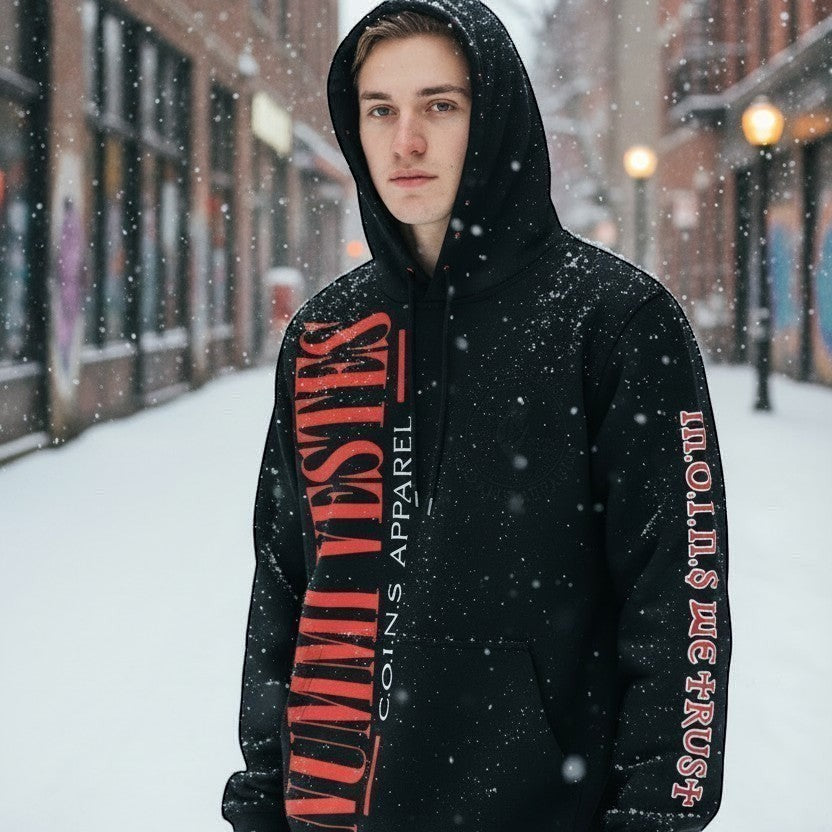 NUMMI VESTES black cotton pullover hoodie with red graphic branding and sleeve typography worn in a snowy city street