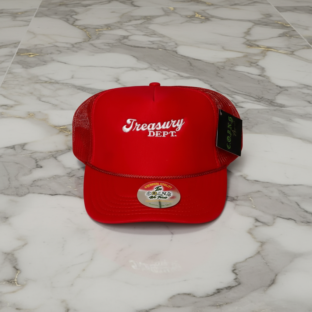 Red cap with 'Treasury Dept.' text on a marble surface