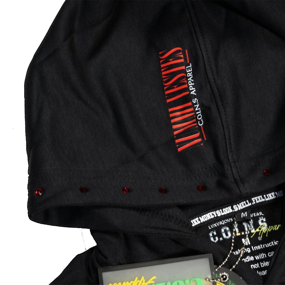 NUMMI VESTES black cotton hoodie featuring red vertical typography on the hood and subtle red stud embellishments.