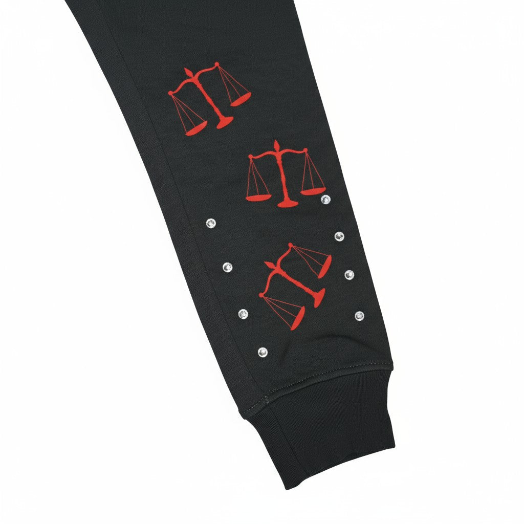 NUMMI VESTES black cotton joggers leg detail featuring red scale of justice graphics and decorative rhinestones