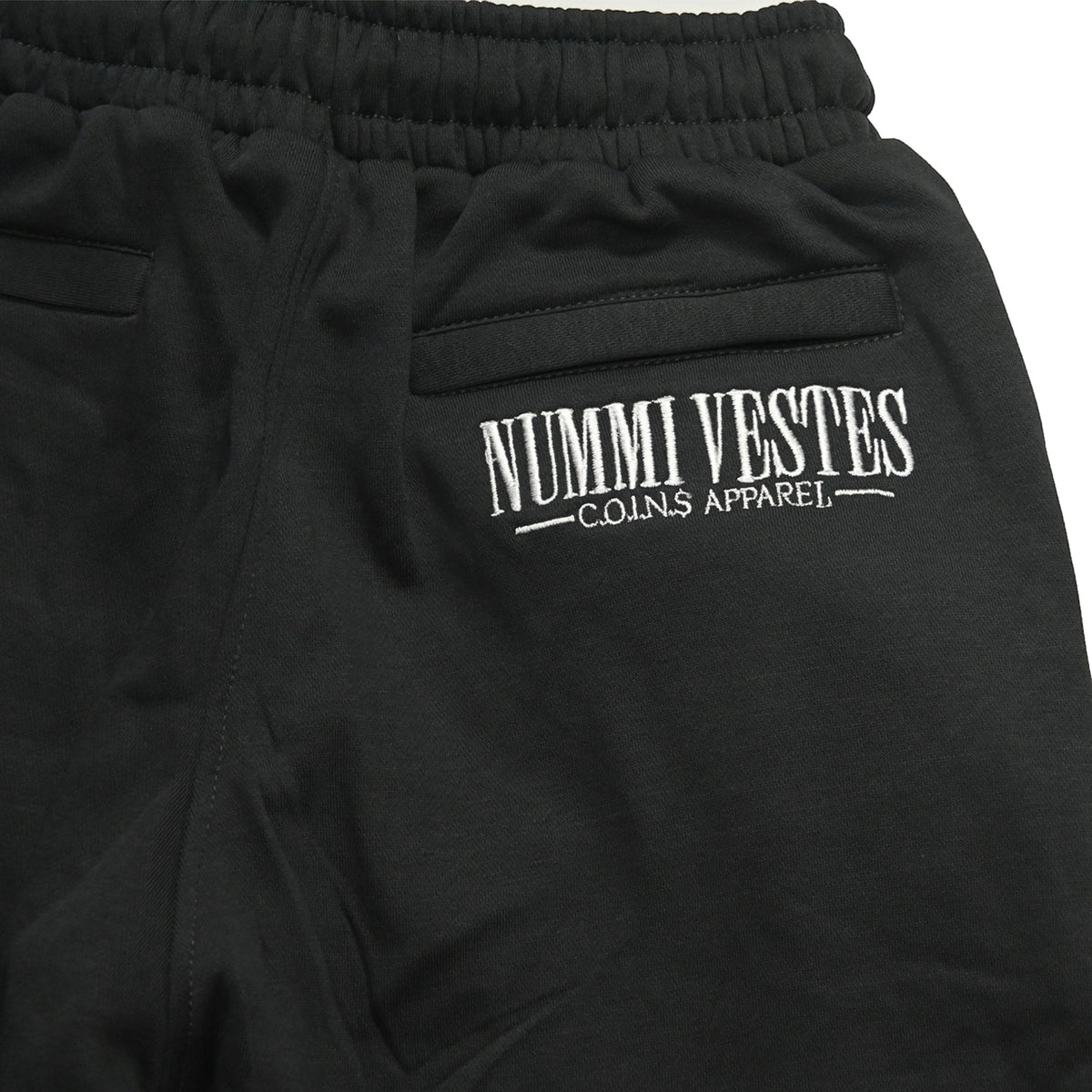 NUMMI VESTES black cotton joggers featuring white embroidered branding on the back pocket