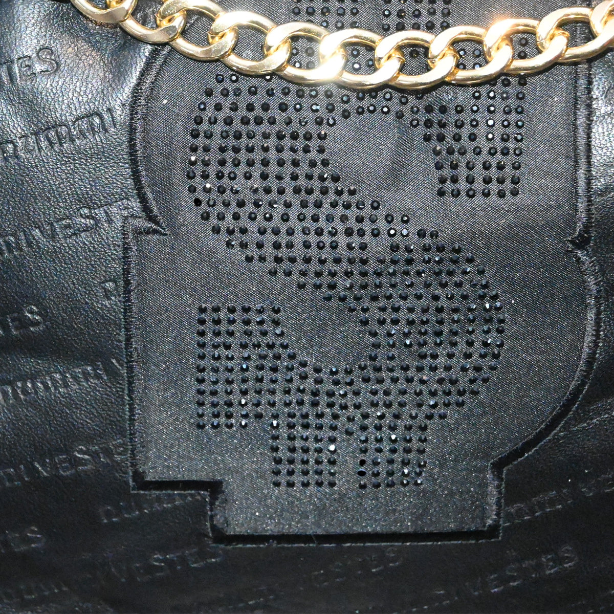 NUMMI VESTES black embossed leather bag featuring a crystal-embellished dollar sign logo and gold-tone chain strap