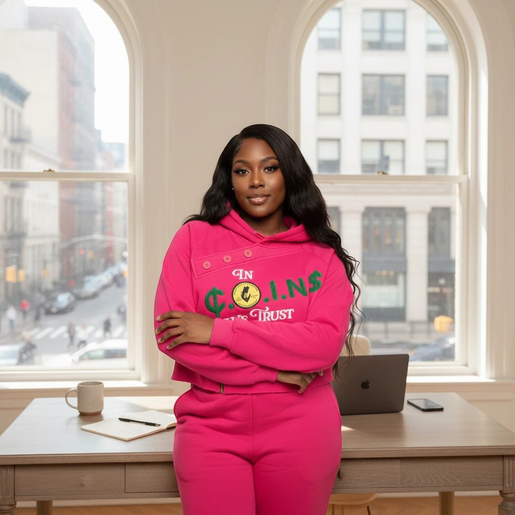 NUMMI VESTES hot pink cropped pullover hoodie with graphic embroidery and button detail worn by a woman in an office