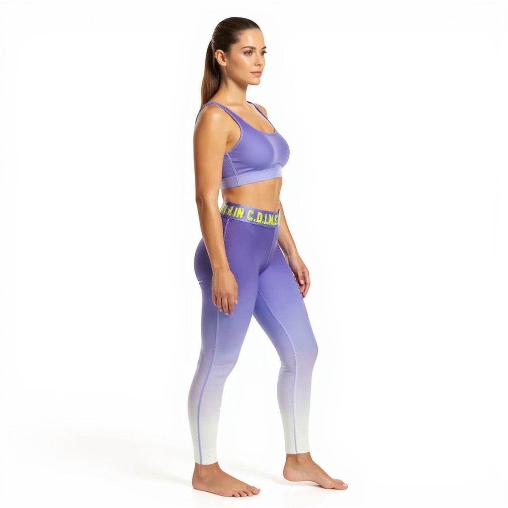 Model wearing NUMMI VESTES purple ombre compression leggings and matching sports bra with branded waistband