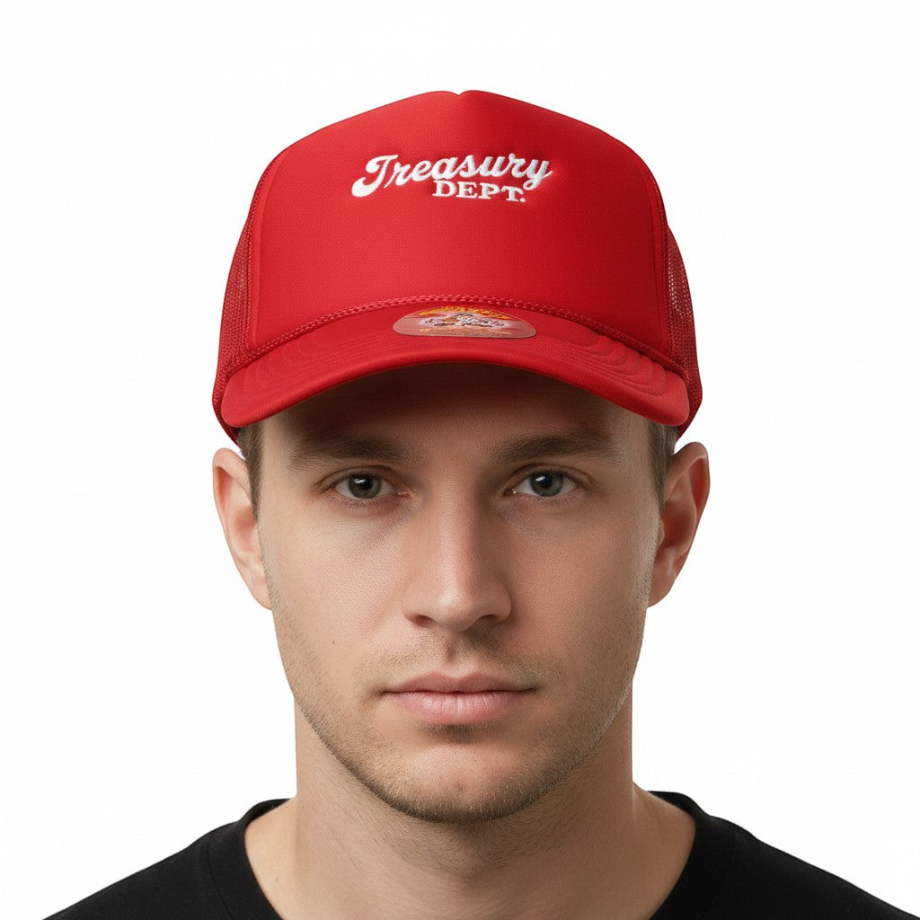 NUMMI VESTES red foam trucker snapback hat with white Treasury Dept embroidery worn by a man