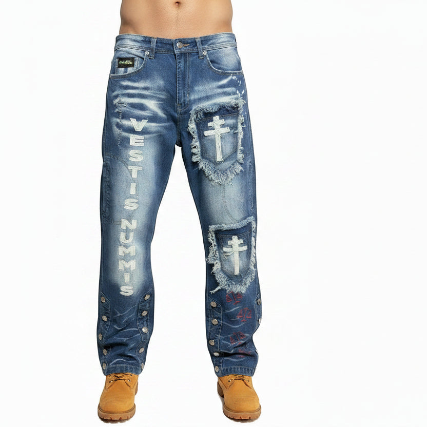 NUMMI VESTES relaxed blue denim jeans with distressed cross patches, vertical text, and buttoned leg hems.